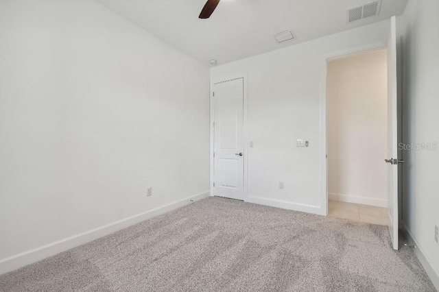 unfurnished bedroom featuring light carpet and ceiling fan