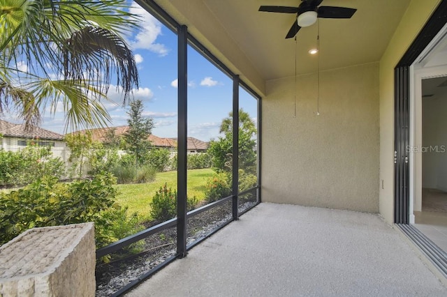 sunroom / solarium featuring ceiling fan