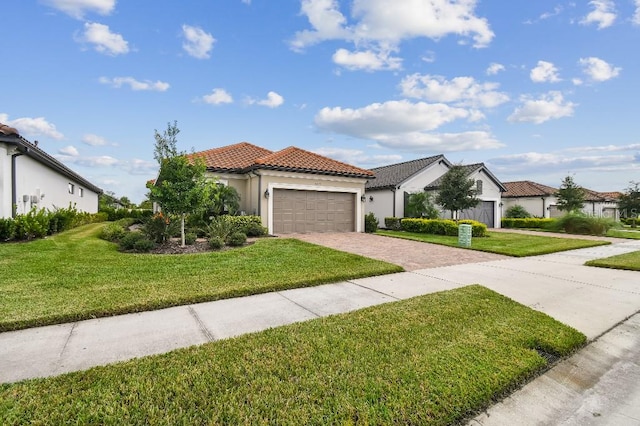 mediterranean / spanish-style house featuring a garage and a front lawn