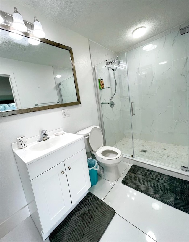 bathroom featuring a shower with door, vanity, a textured ceiling, and toilet