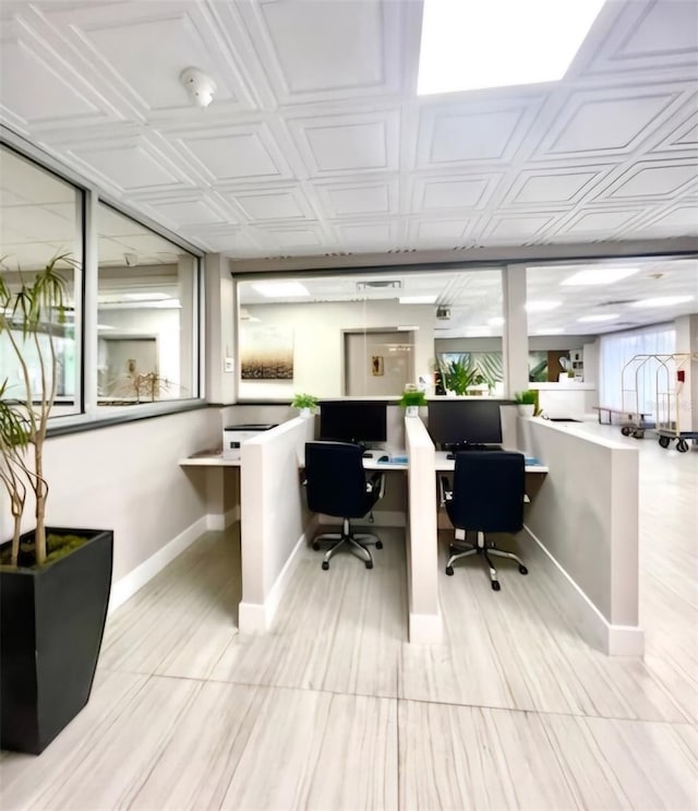 office space featuring baseboards and an ornate ceiling