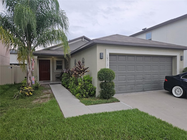 ranch-style home with a garage and a front lawn