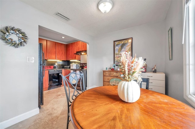 dining area featuring a textured ceiling