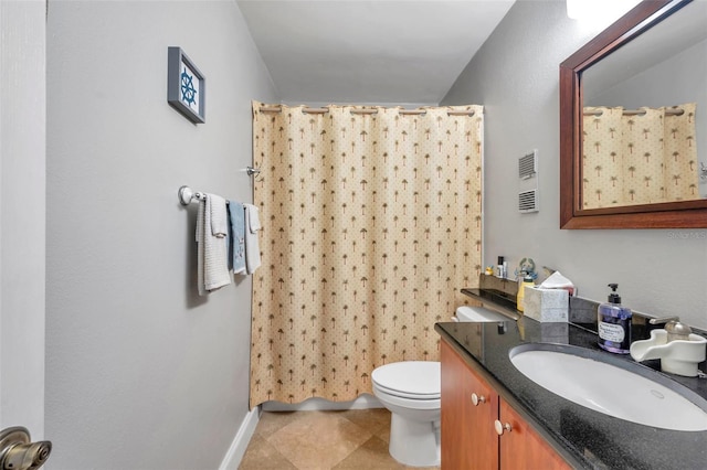 bathroom with curtained shower, vanity, and toilet