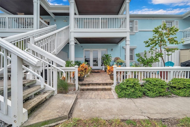 doorway to property featuring a balcony and french doors