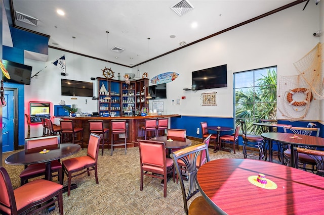 playroom featuring ornamental molding, carpet floors, and bar