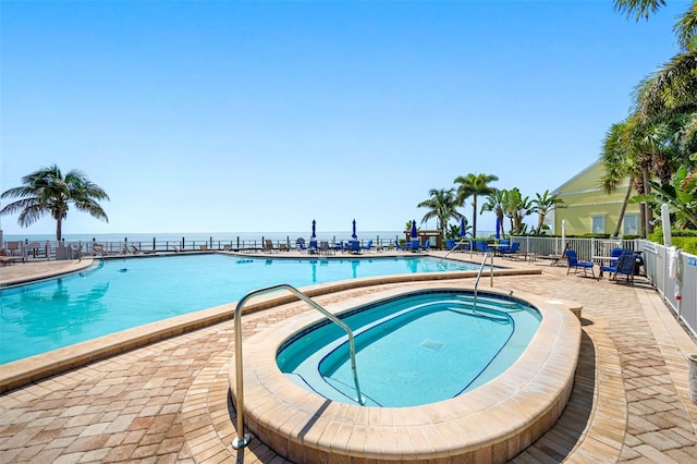 view of swimming pool featuring a patio and a community hot tub