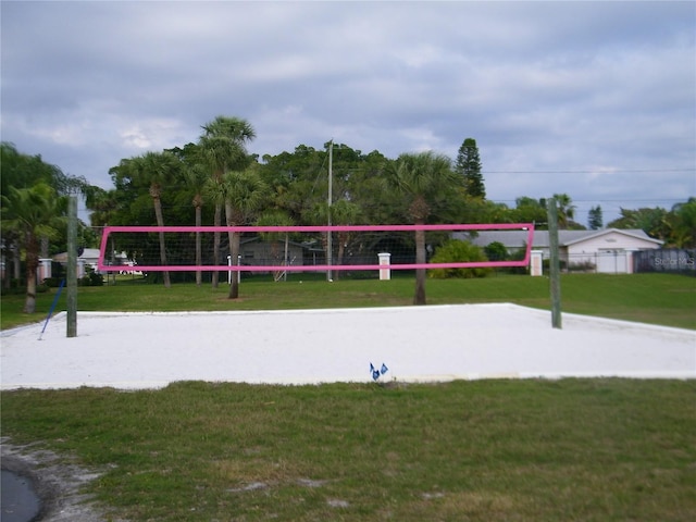 view of community with a lawn and volleyball court