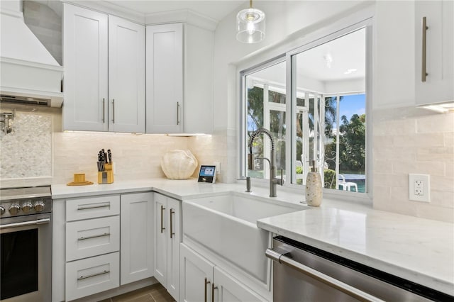 kitchen with tasteful backsplash, stainless steel appliances, custom range hood, and white cabinets