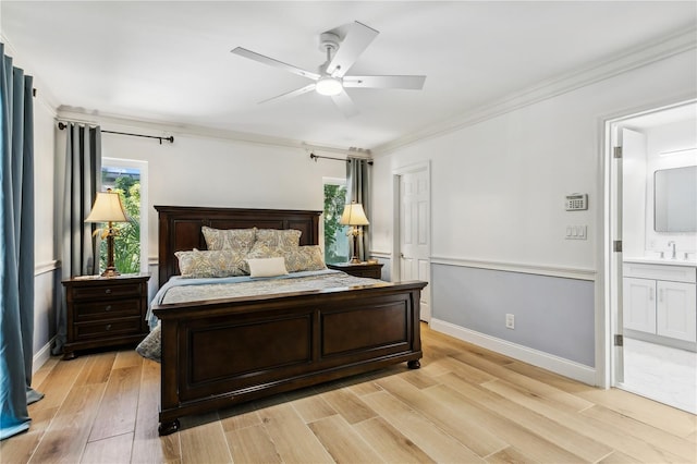 bedroom featuring connected bathroom, sink, ornamental molding, ceiling fan, and light wood-type flooring