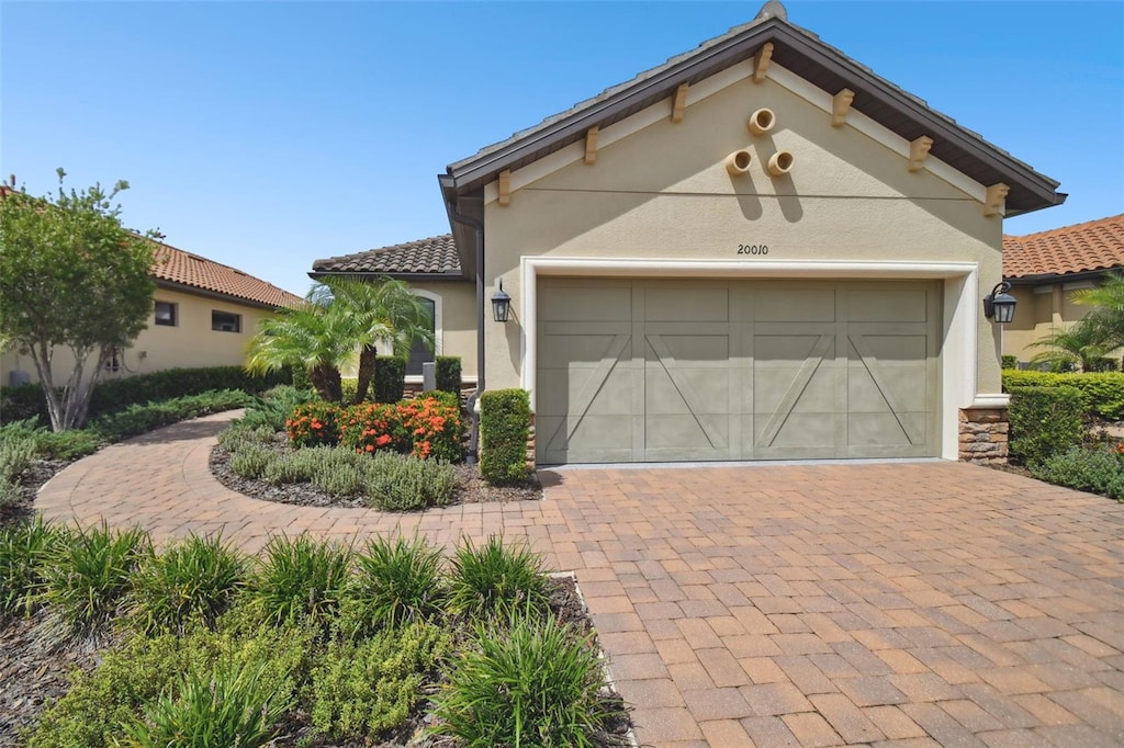 mediterranean / spanish-style house with a garage