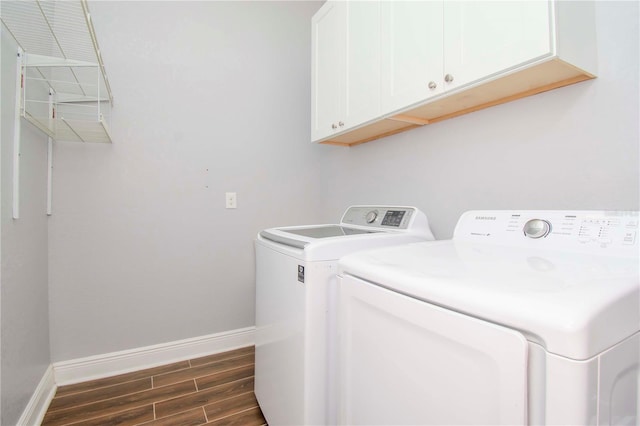 laundry room with cabinets and washing machine and clothes dryer