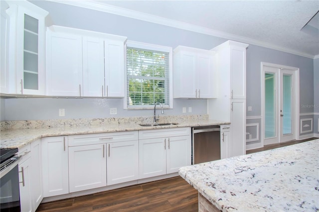 kitchen with stainless steel appliances, white cabinetry, sink, and ornamental molding