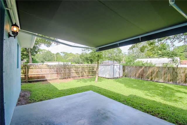 view of yard featuring a shed and a patio area