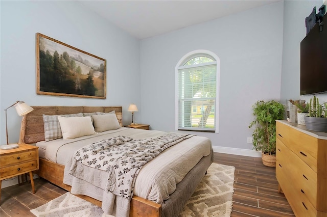 bedroom with dark hardwood / wood-style floors