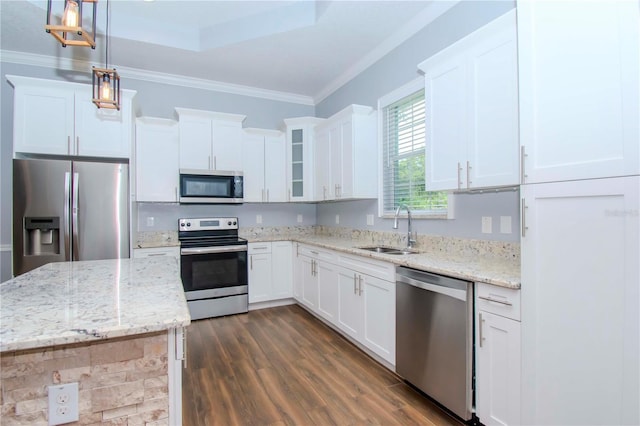 kitchen featuring white cabinetry, appliances with stainless steel finishes, sink, and pendant lighting