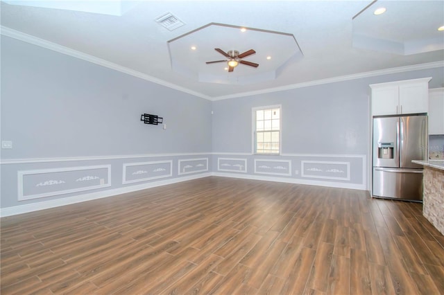 unfurnished living room with crown molding, ceiling fan, dark hardwood / wood-style floors, and a raised ceiling