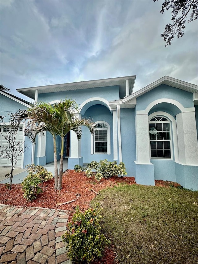 view of front of property featuring a garage and a front lawn