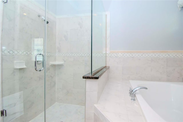 bathroom with a stall shower and a garden tub