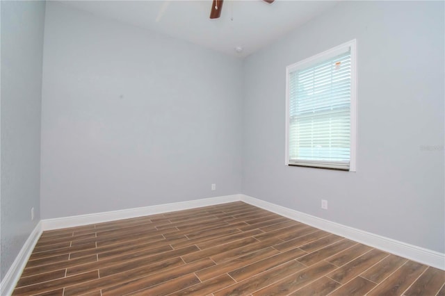 empty room featuring dark wood-type flooring, ceiling fan, and baseboards