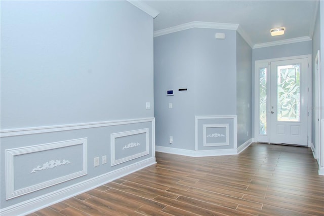 entrance foyer with crown molding, baseboards, and wood finished floors