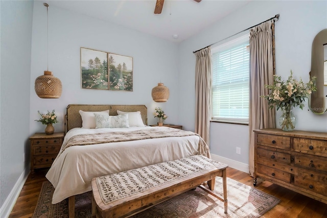 bedroom featuring a ceiling fan, baseboards, and wood finished floors