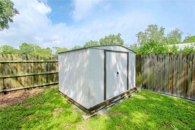 view of shed with a fenced backyard