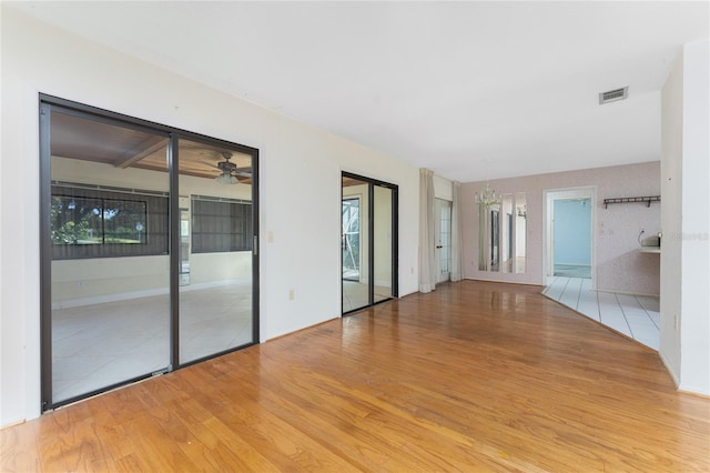 spare room with light hardwood / wood-style flooring and ceiling fan