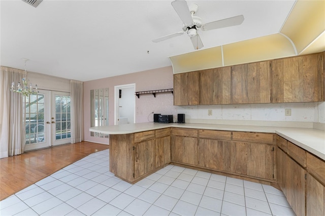 kitchen with ceiling fan, light hardwood / wood-style flooring, french doors, and kitchen peninsula