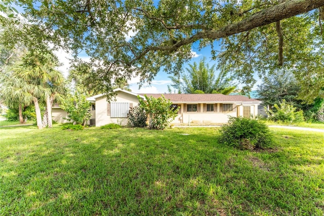 ranch-style home with a front lawn