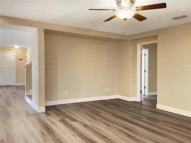 spare room with hardwood / wood-style floors and ceiling fan