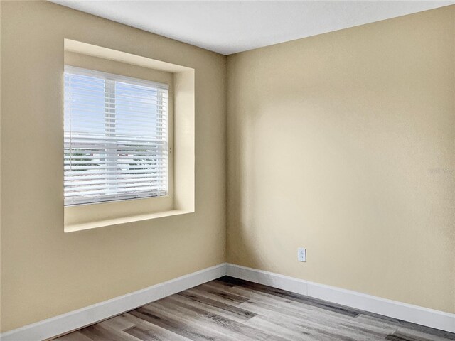 unfurnished room with hardwood / wood-style flooring