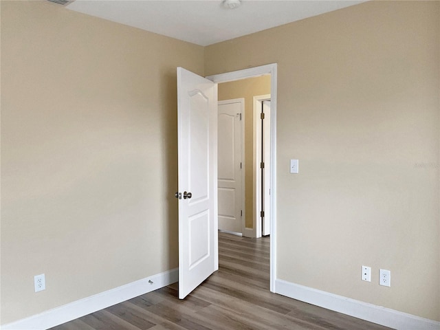 empty room with hardwood / wood-style flooring