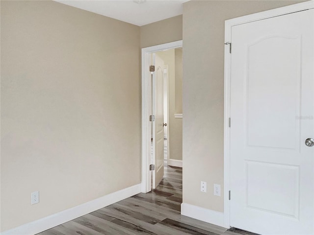 unfurnished bedroom featuring dark hardwood / wood-style flooring