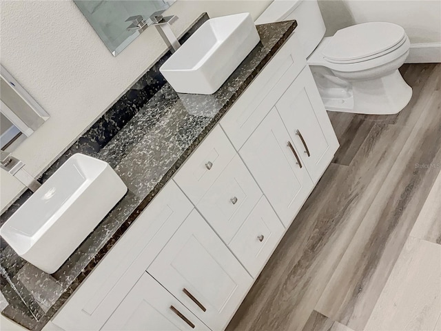 bathroom featuring hardwood / wood-style floors, toilet, and vanity