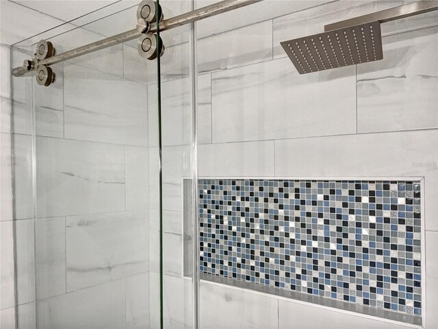 details featuring a shower with shower door