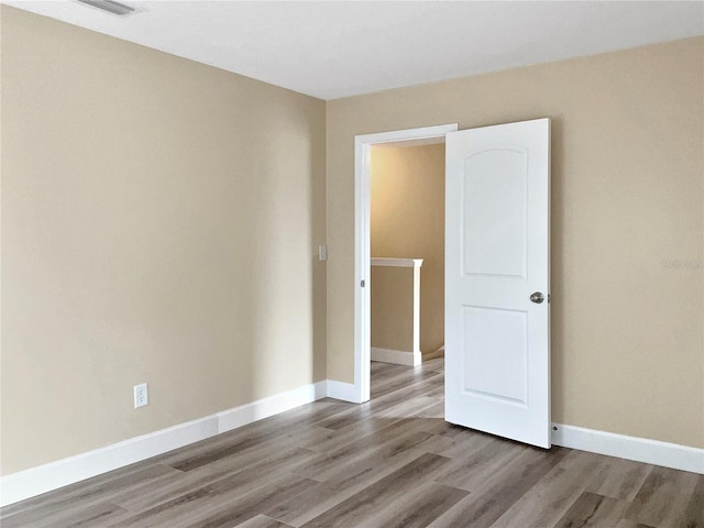 spare room with light hardwood / wood-style flooring