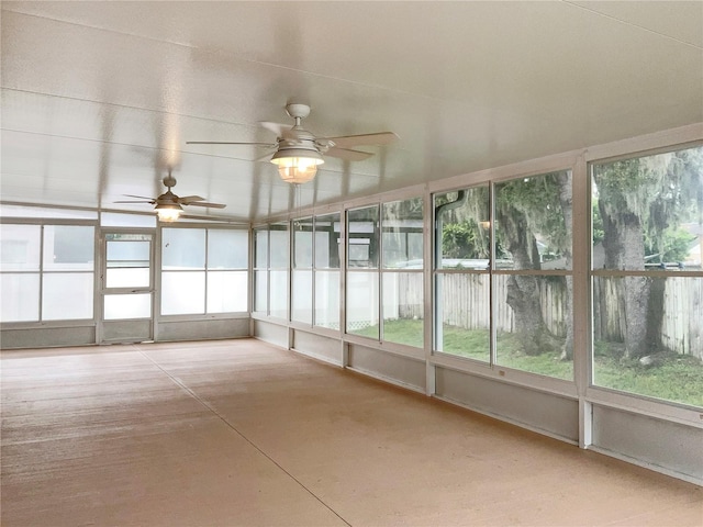 unfurnished sunroom featuring ceiling fan