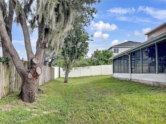 view of yard with a sunroom