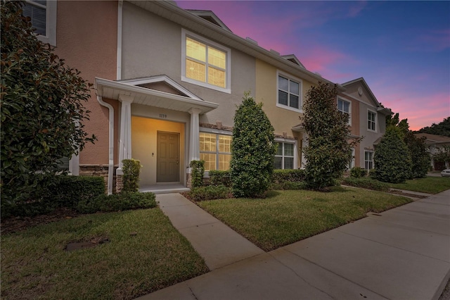 view of front of home with a lawn