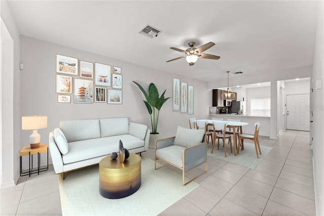 tiled living room featuring ceiling fan