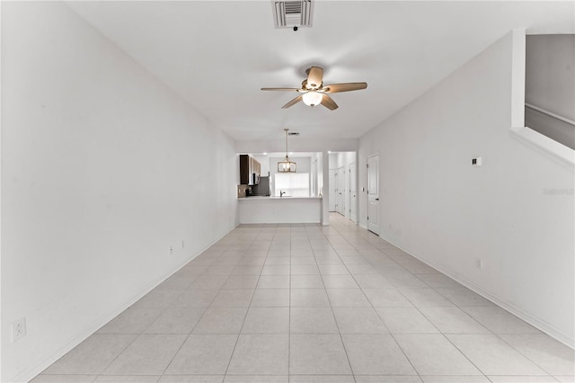 spare room with light tile patterned floors and ceiling fan