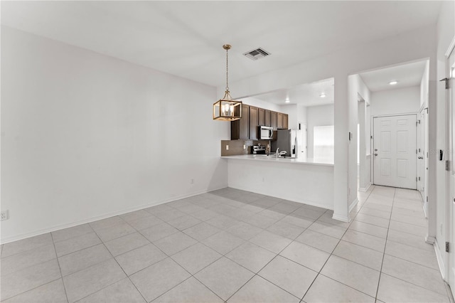 unfurnished living room featuring sink and light tile patterned floors