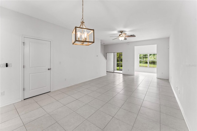 unfurnished room featuring ceiling fan with notable chandelier and light tile patterned flooring