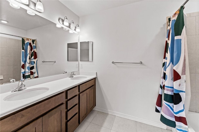 bathroom featuring tile patterned flooring, vanity, and curtained shower