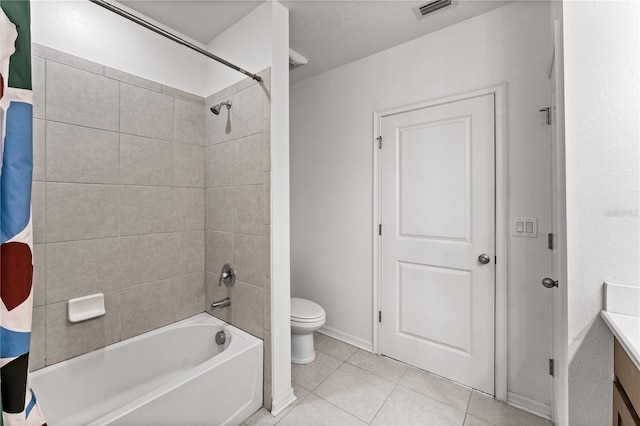 full bathroom featuring tile patterned flooring, shower / bath combo, vanity, and toilet