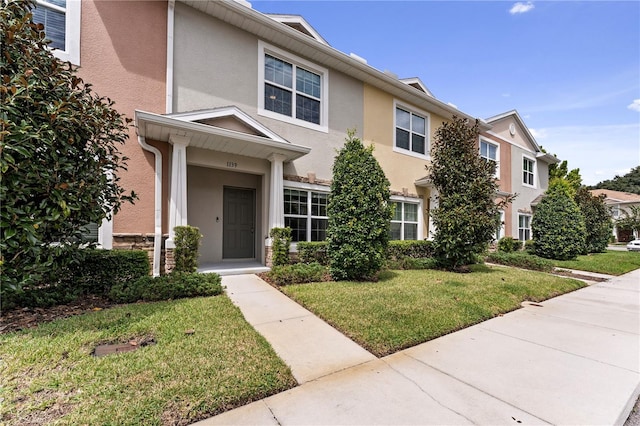 view of property featuring a front lawn