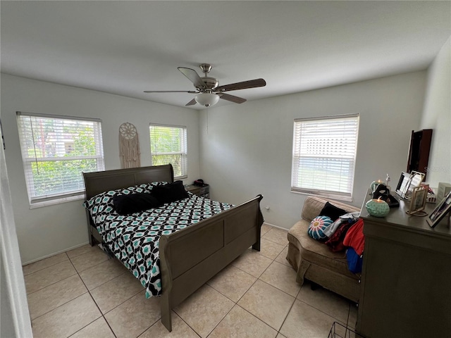 tiled bedroom featuring ceiling fan