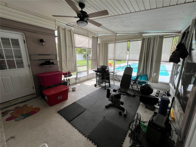 sunroom / solarium featuring ceiling fan