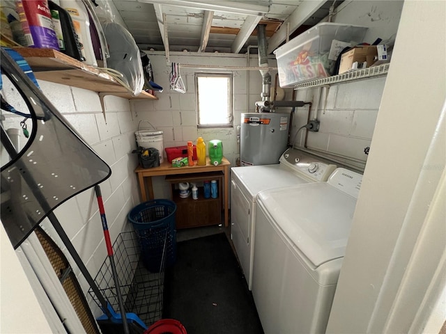 laundry area with gas water heater and independent washer and dryer